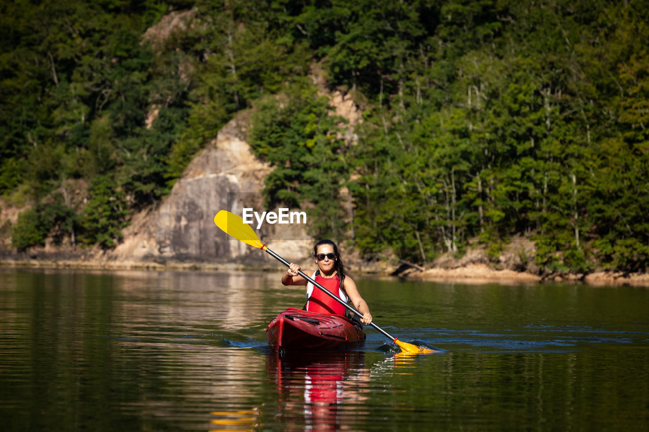 Young woman kayaking in lake