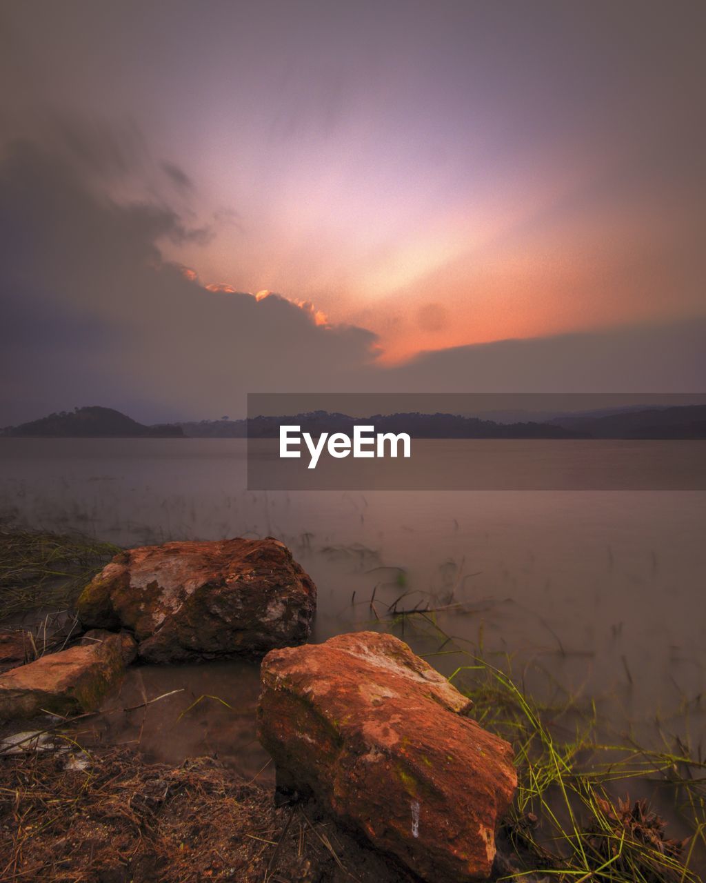 Scenic view of lake against sky during sunset