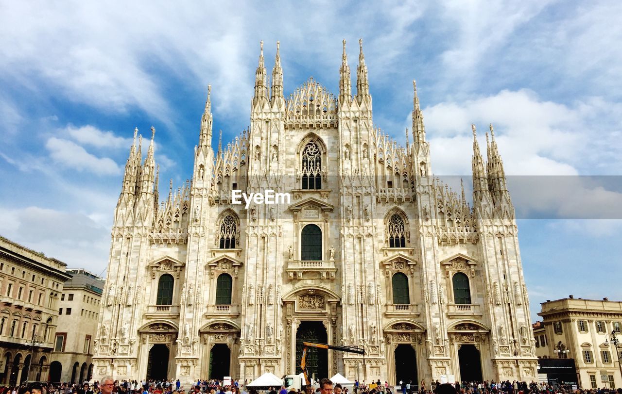 People at milan cathedral against sky