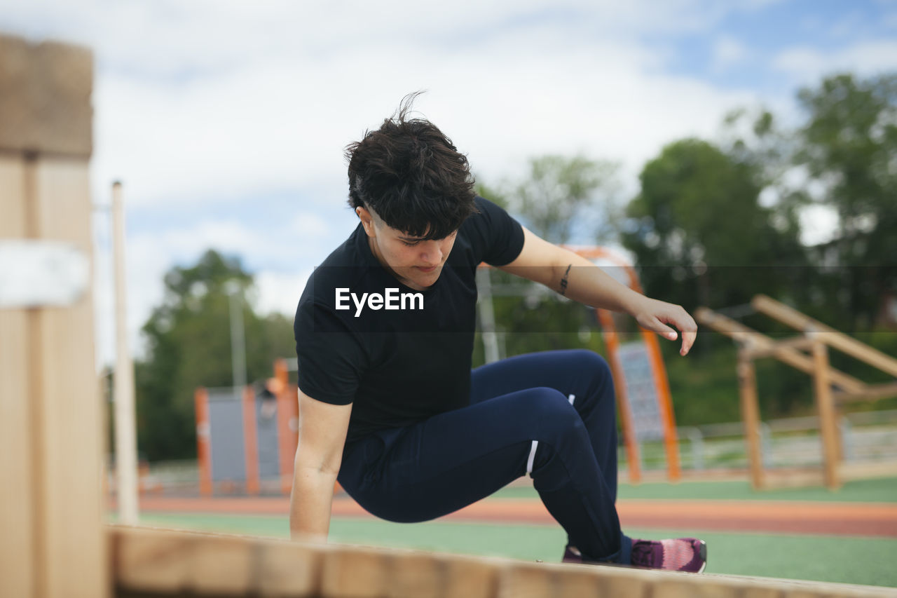 Young woman exercising at outdoor gym