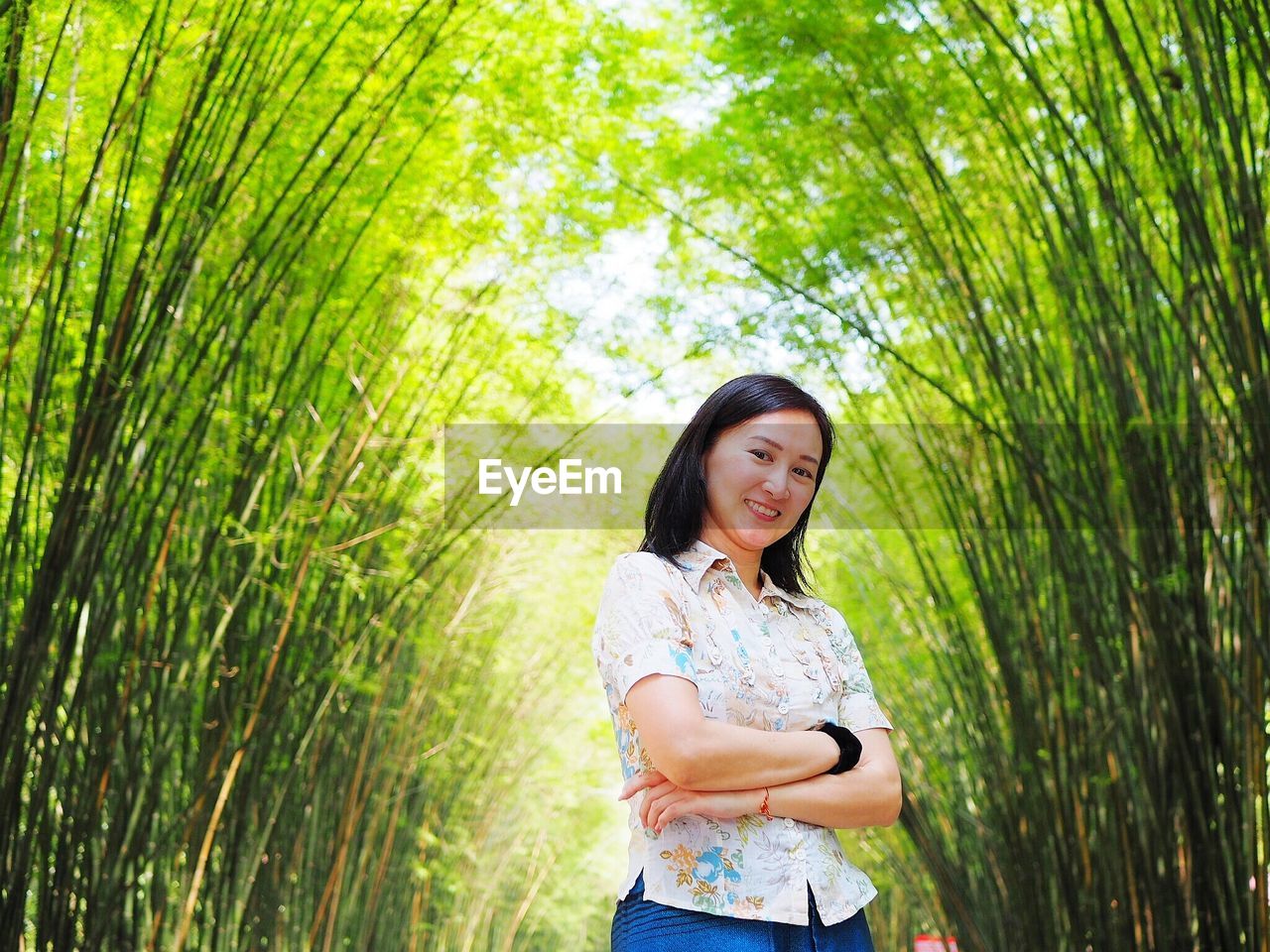 Smiling woman standing by plants