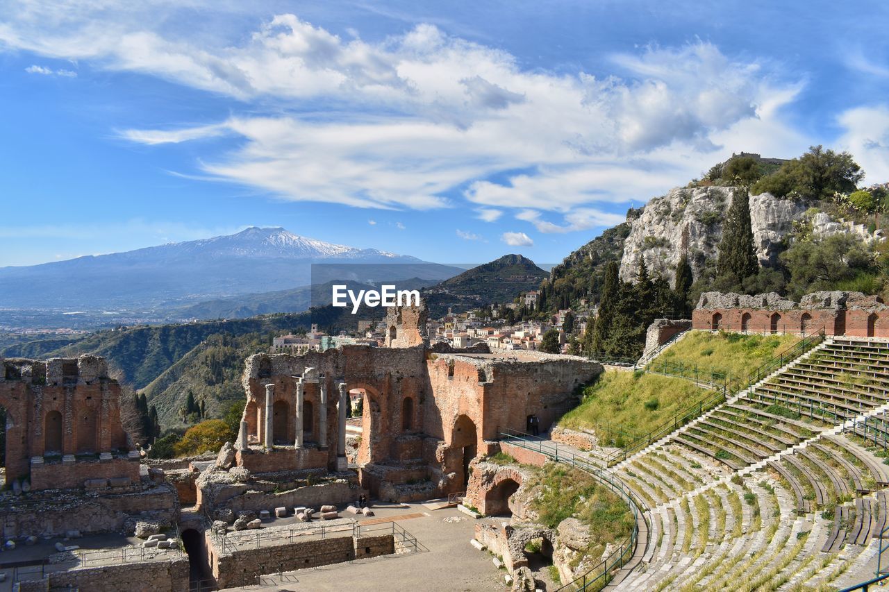 Panoramic view of a ruin against cloudy sky