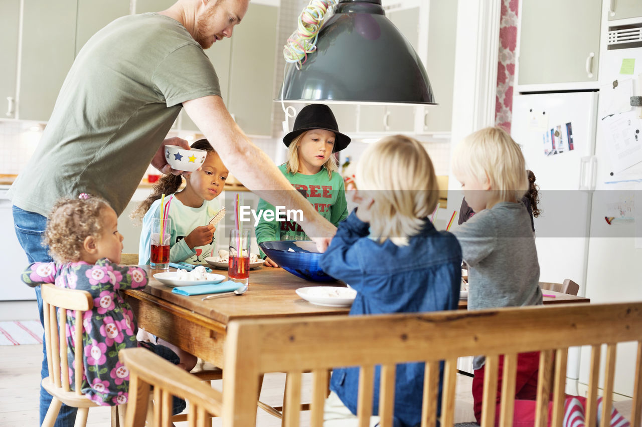 Father and children in kitchen