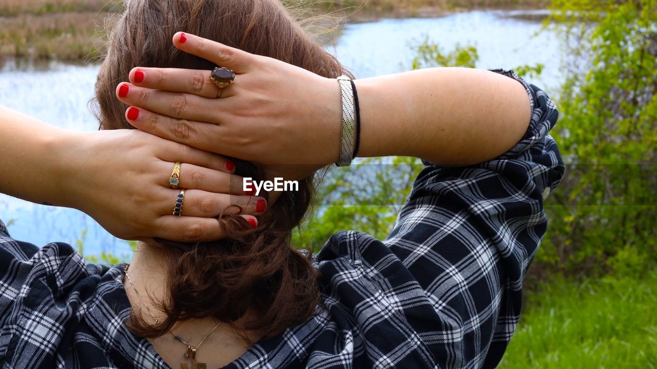  close-up of woman with hands behind head