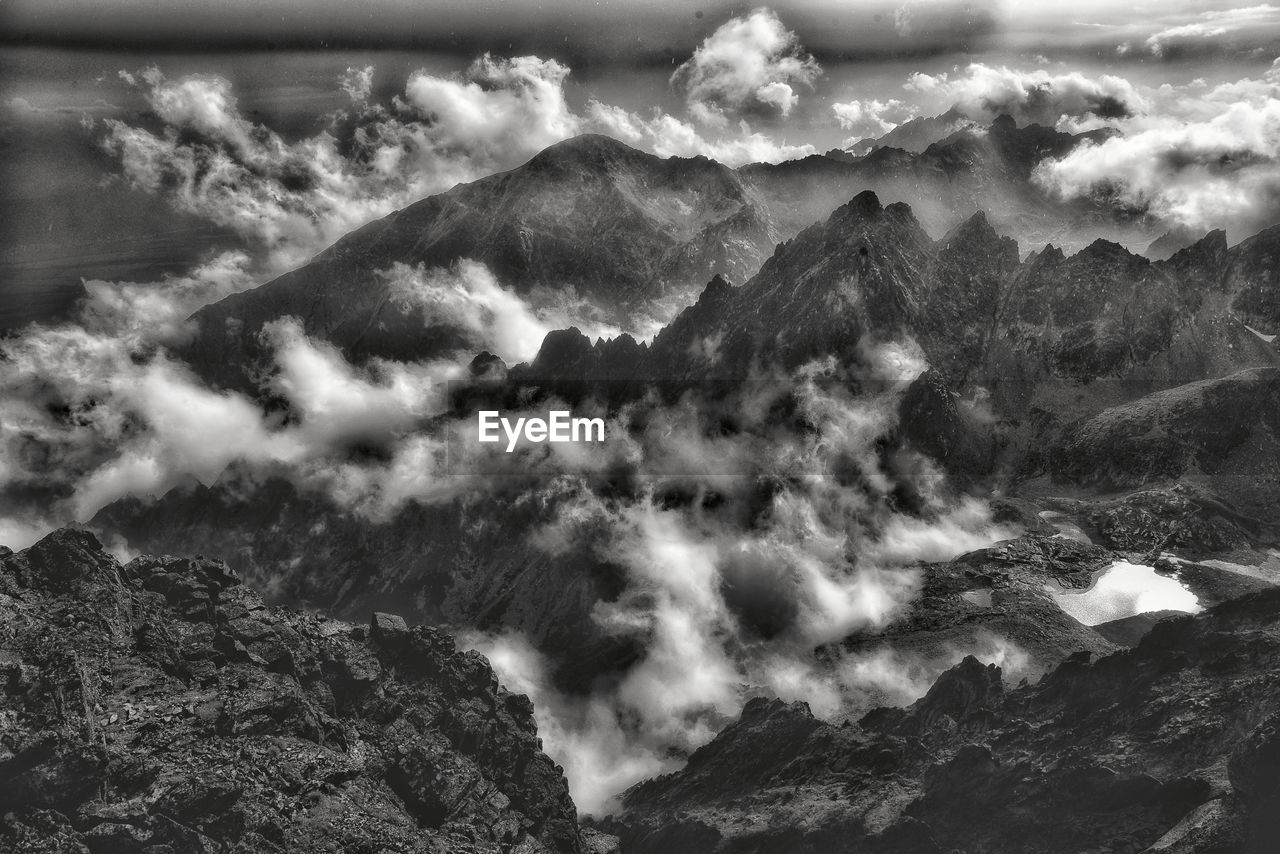 SCENIC VIEW OF CLOUDS OVER MOUNTAINS
