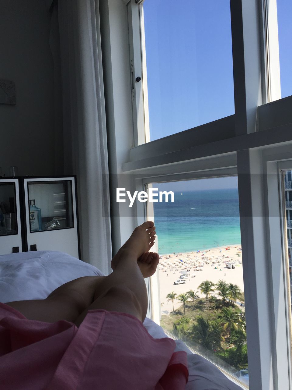 Low section of woman relaxing in beach side hotel