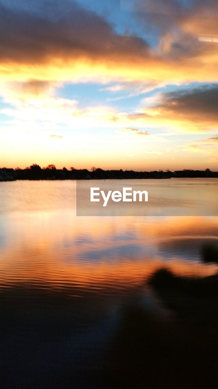 SCENIC VIEW OF SUNSET OVER SEA