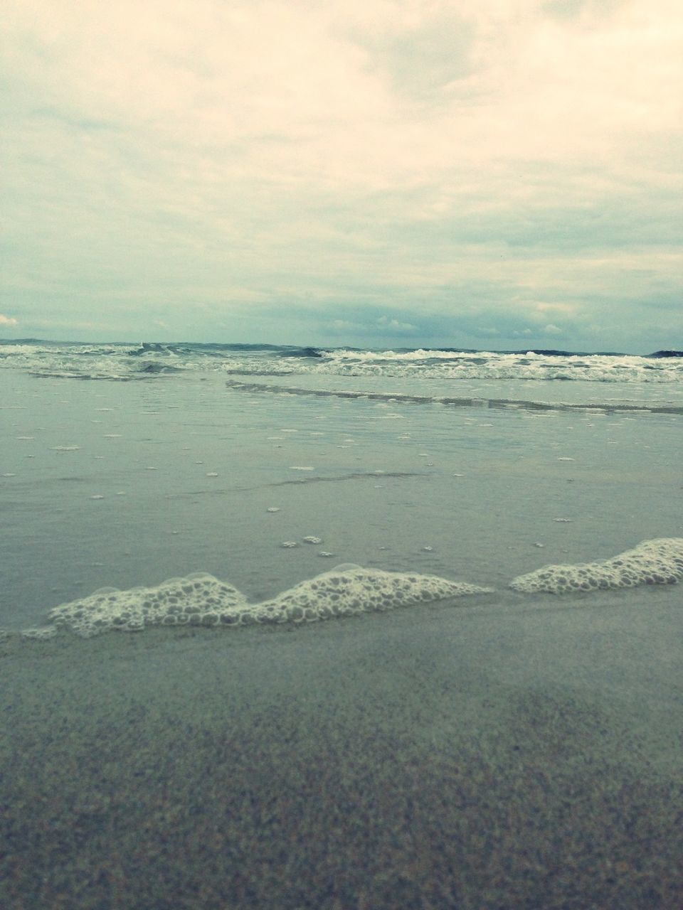 Scenic view of sea shore against blue sky