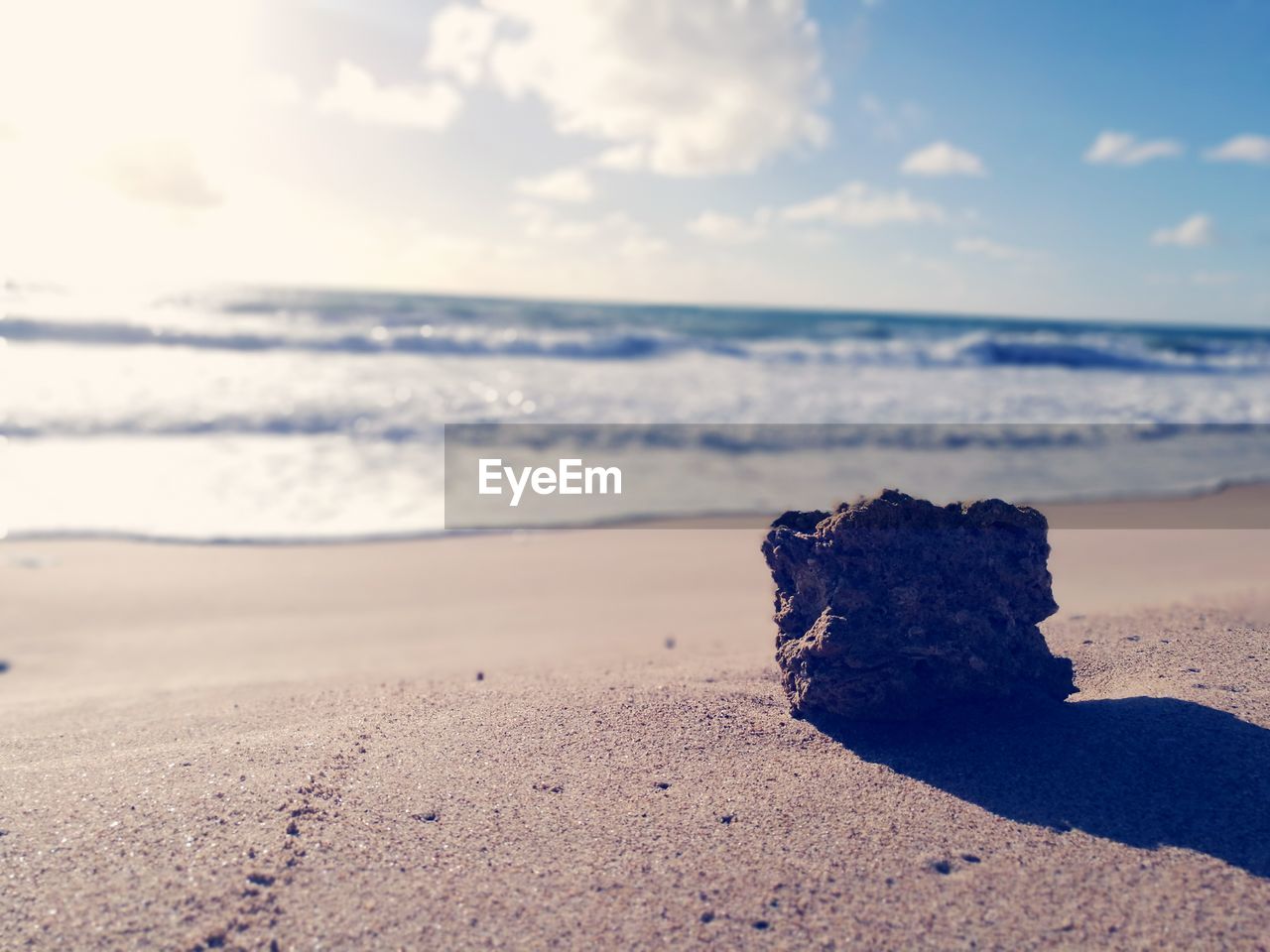 ROCKS ON BEACH AGAINST SKY