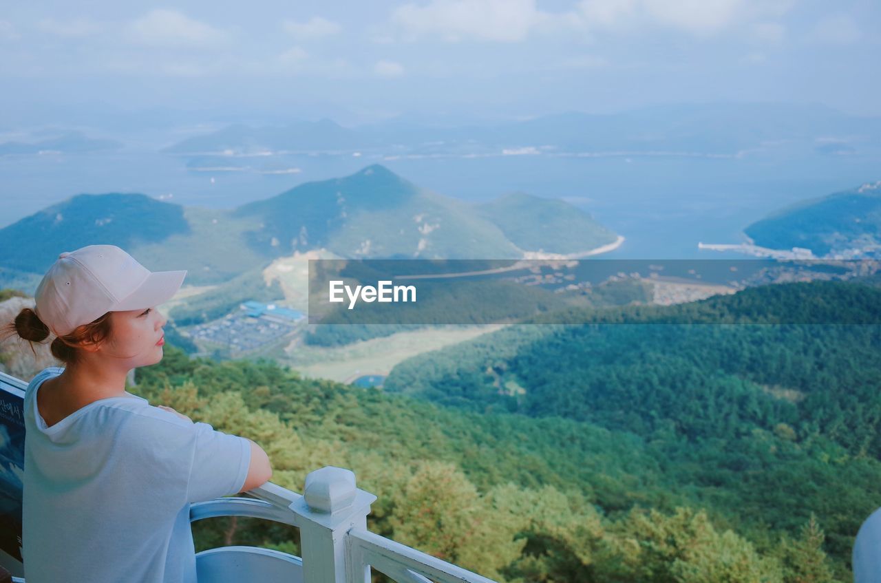 Woman looking down from lookout tower