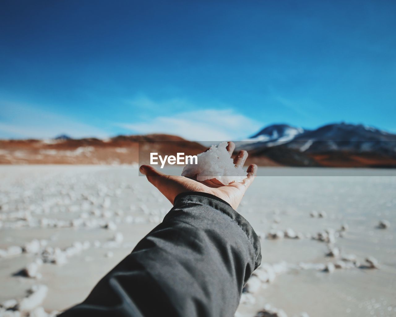 Person holding snow on palm