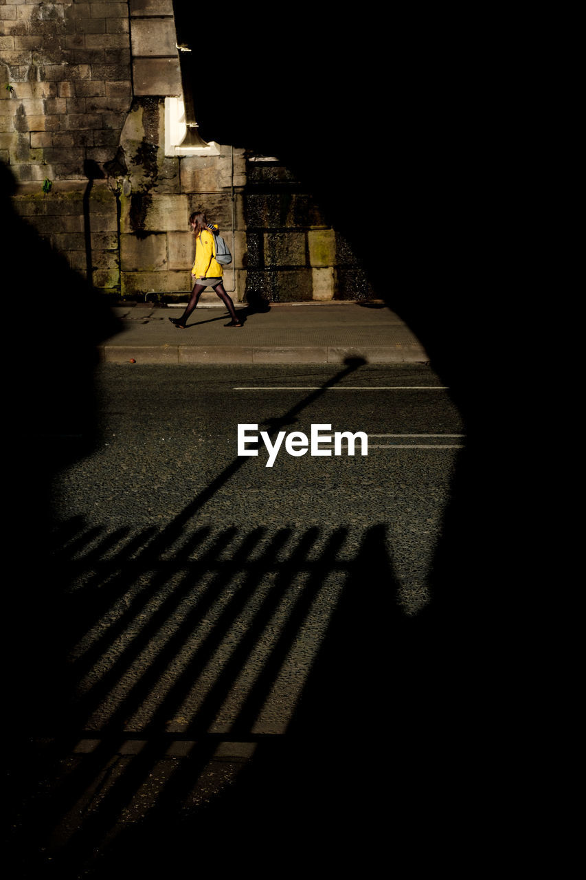 SHADOW OF PERSON RIDING BICYCLE ON STREET