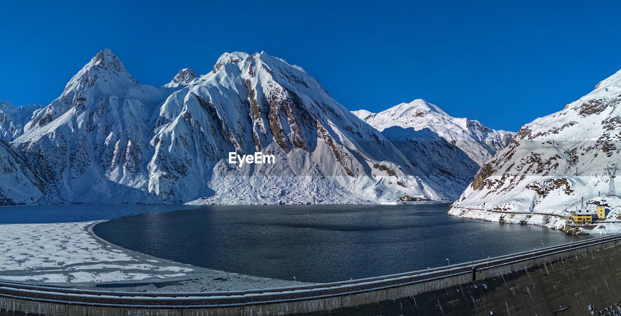 scenic view of snowcapped mountains against clear blue sky