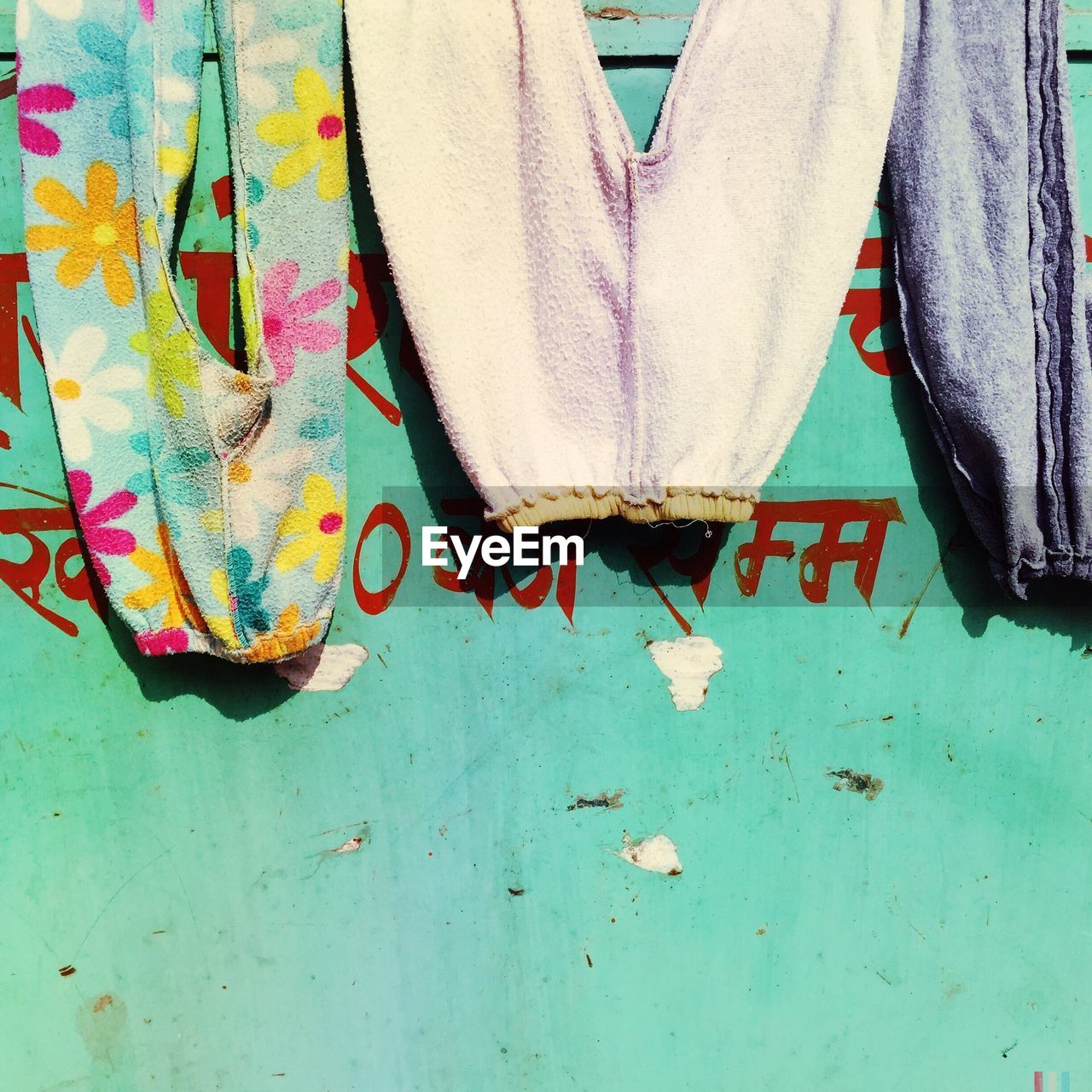 CLOSE-UP OF CLOTHES HANGING ON PAPER