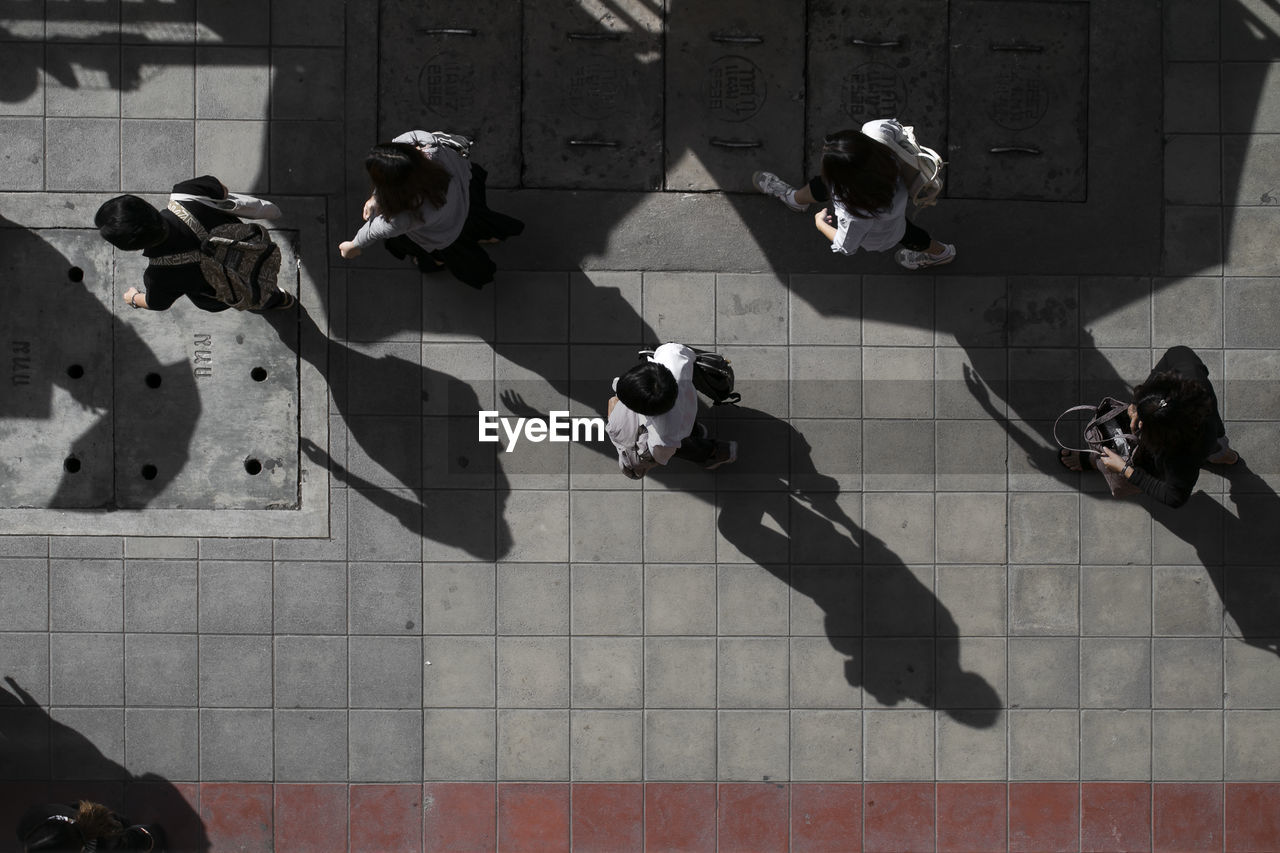 High angle view of people standing on footpath