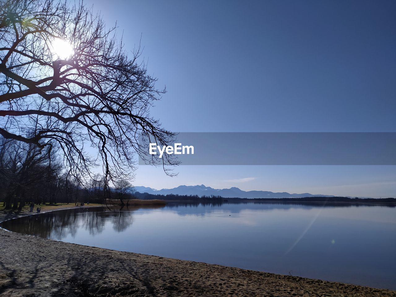 Scenic view of lake against clear blue sky