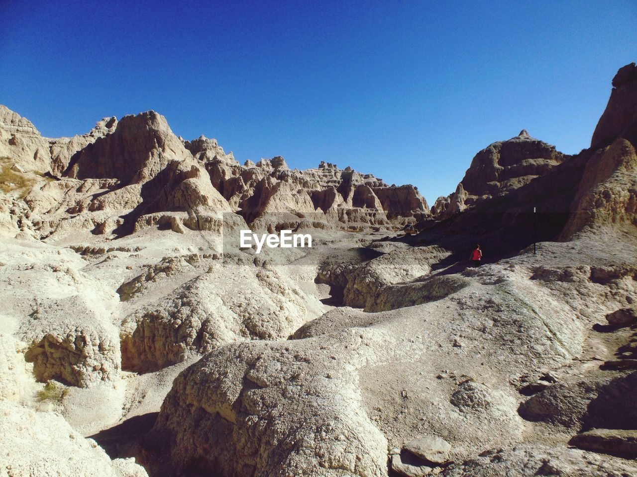 Scenic view of badlands national park against clear blue sky