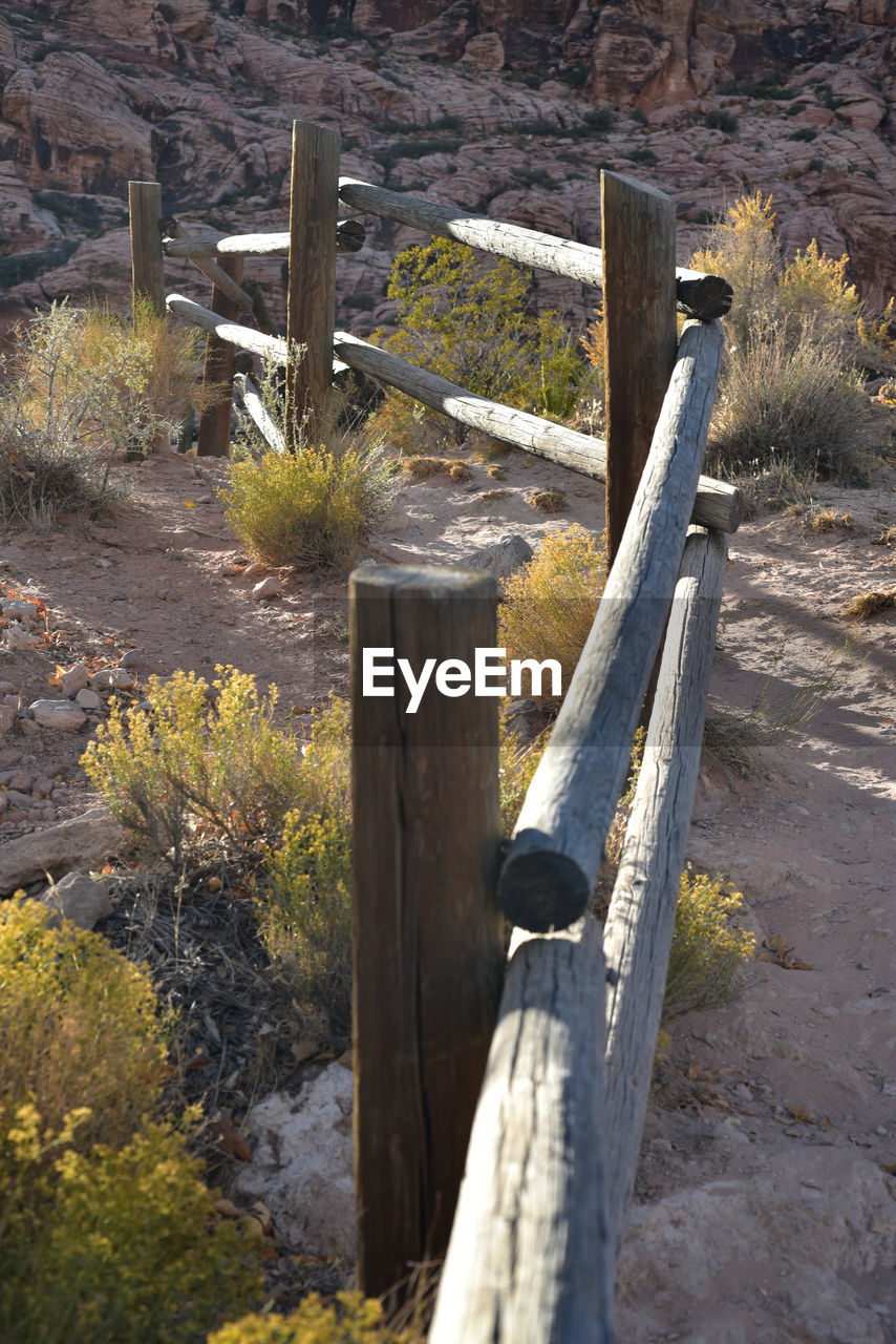 WOODEN POST ON FIELD