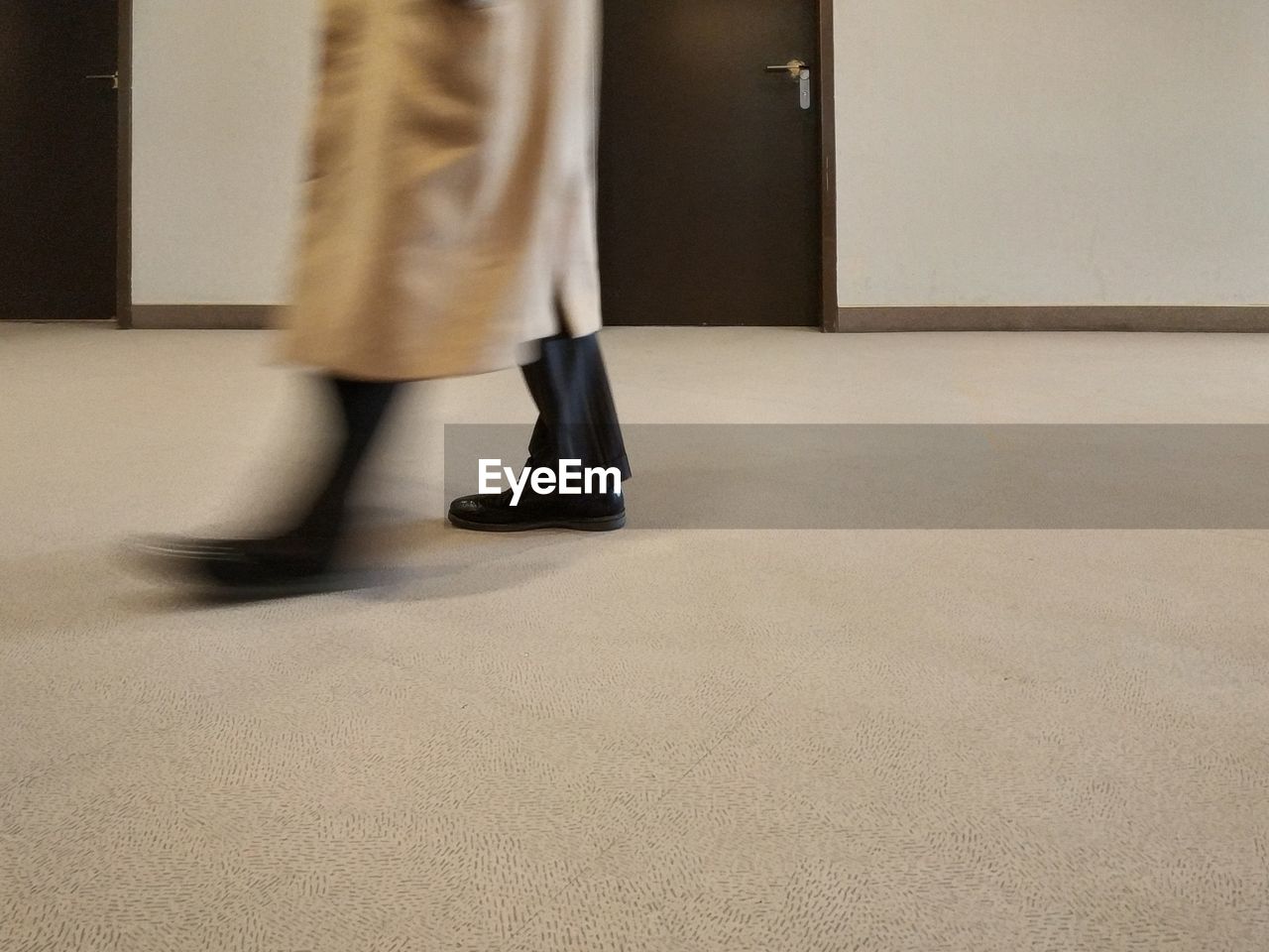 Low section of woman standing on floor in building