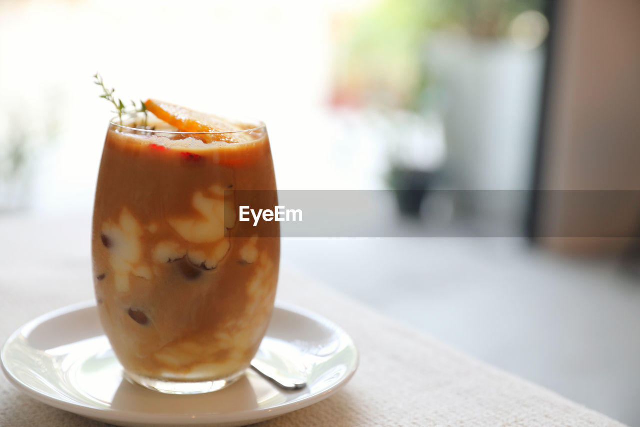 CLOSE-UP OF COFFEE IN GLASS