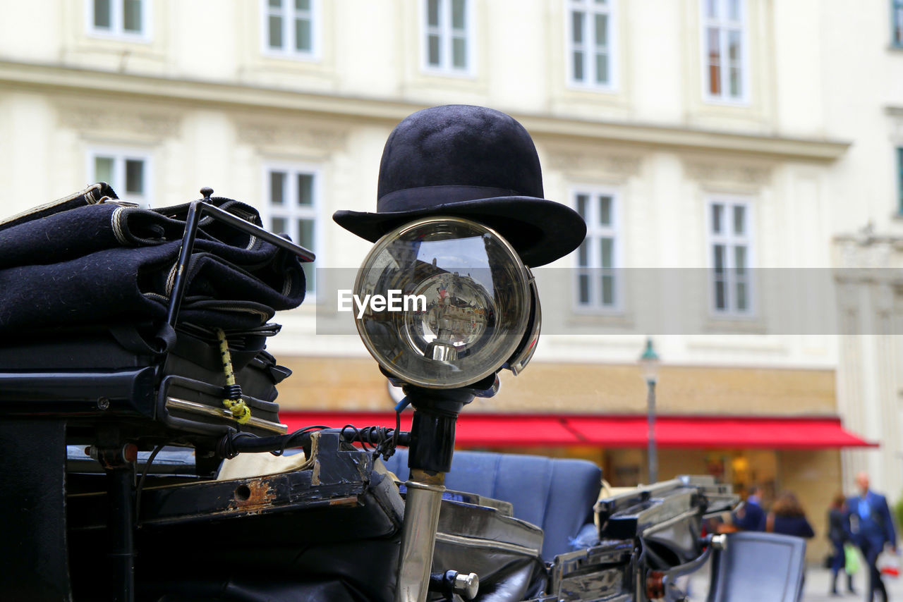 The black hat on a spotlight of a carriage. vienna, austria.