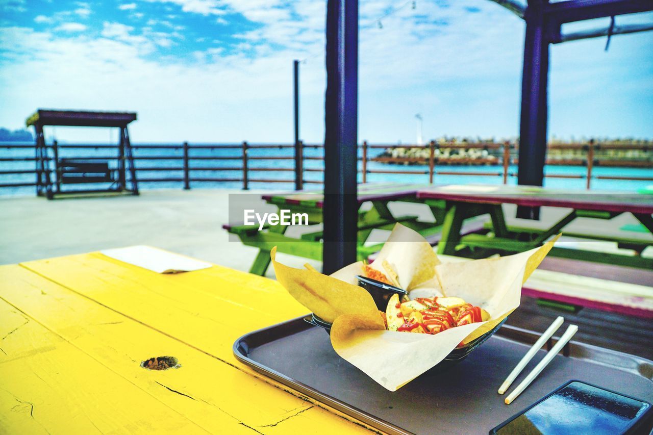 Food in tray on table at outdoor restaurant