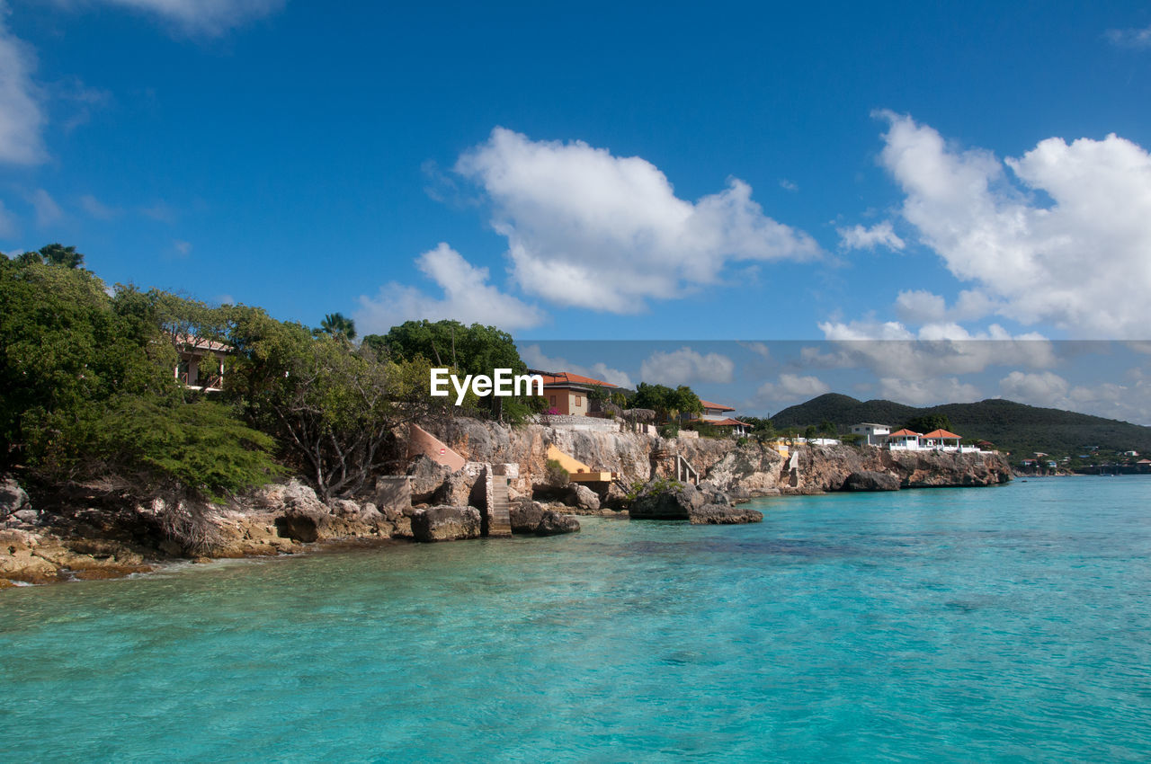 scenic view of sea and buildings against sky