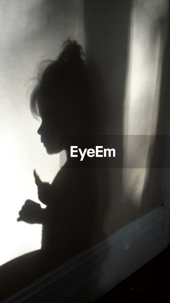 Shadow of girl on wall