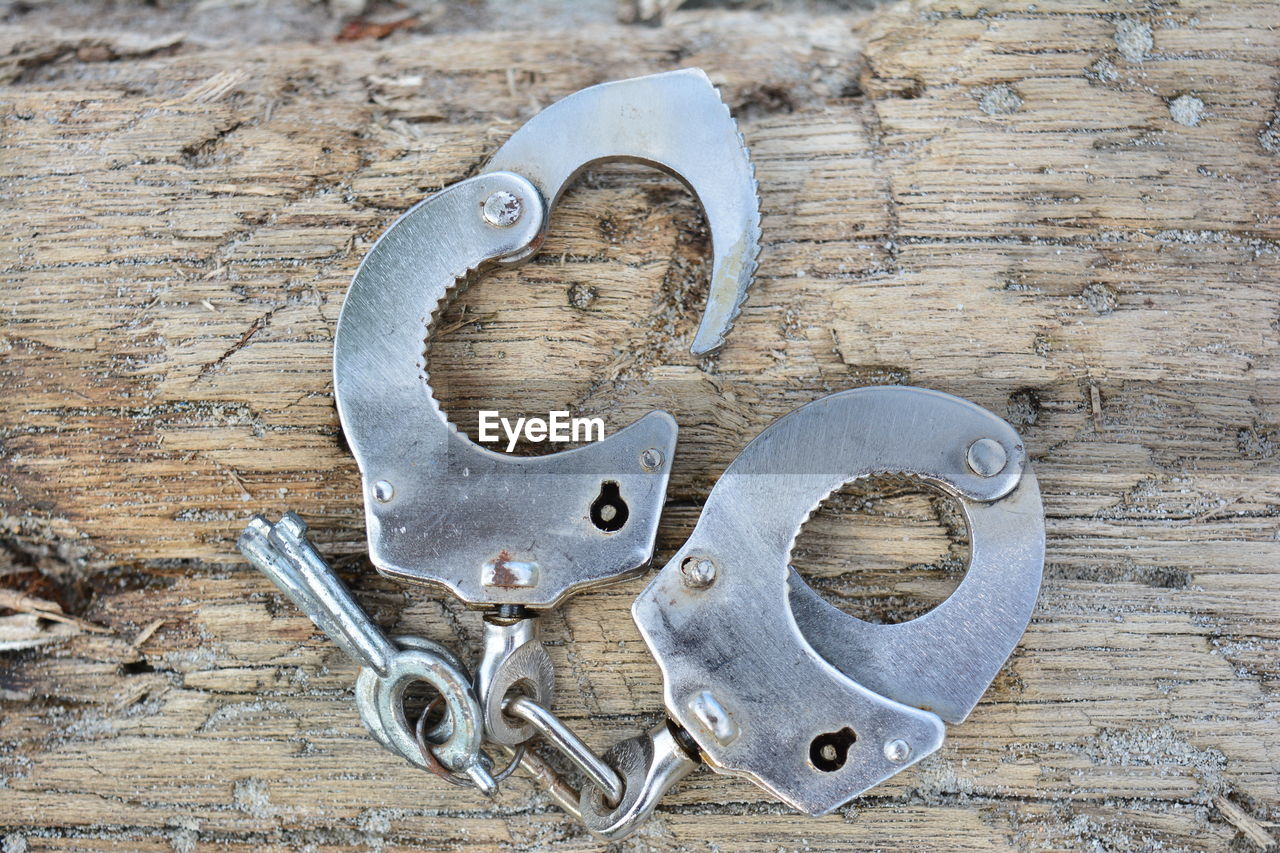 Close-up of handcuffs on textured table