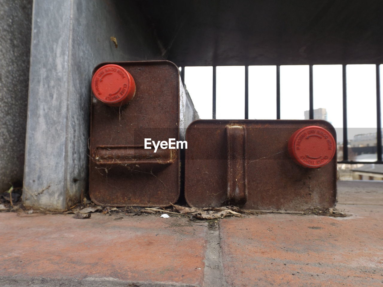 Rusty metal containers in room