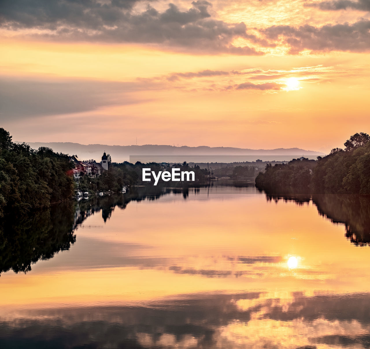 Scenic view of lake against orange sky