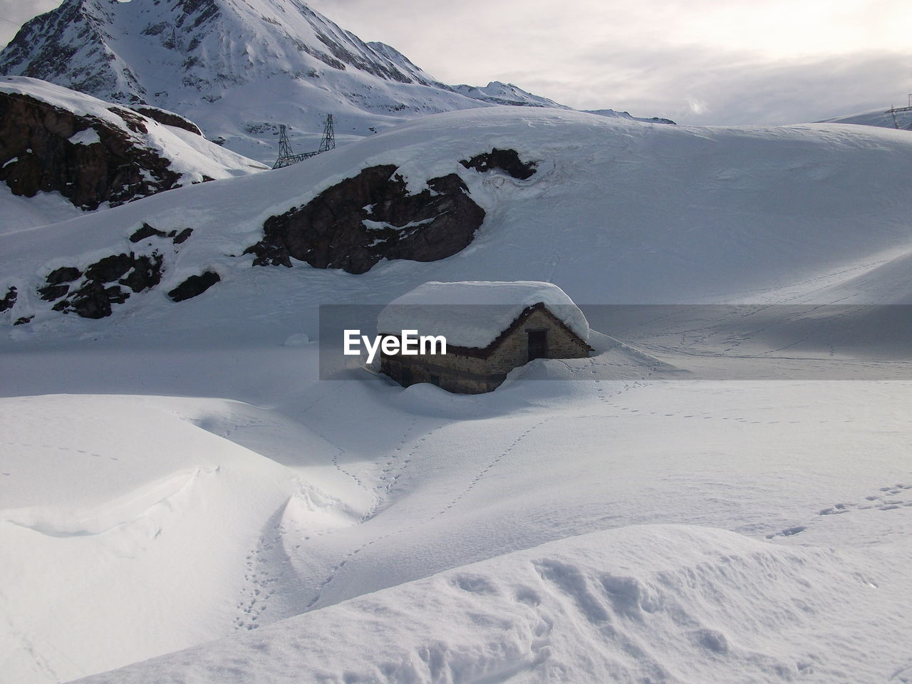 Scenic view of snow covered mountains against sky