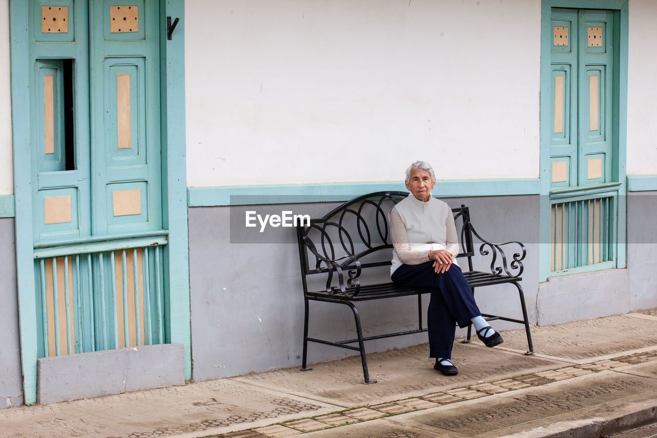 Senior woman traveling at the small town of salento, located on the region of quindio in colombia