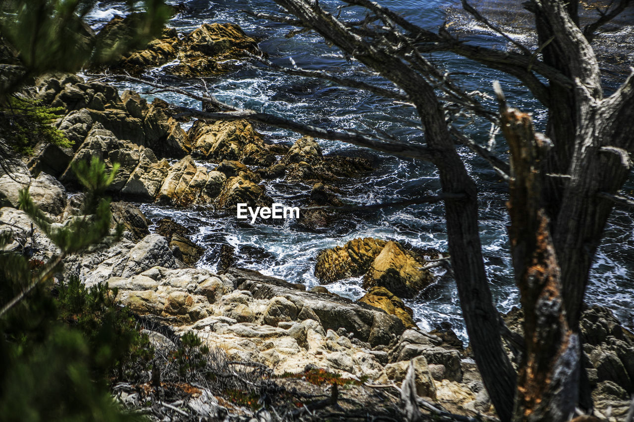 High angle view of rocks on sea