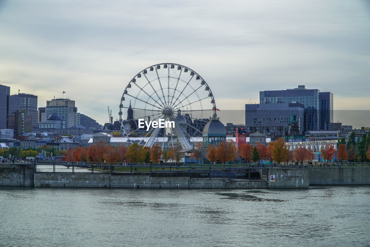 Ferris wheel in city against sky