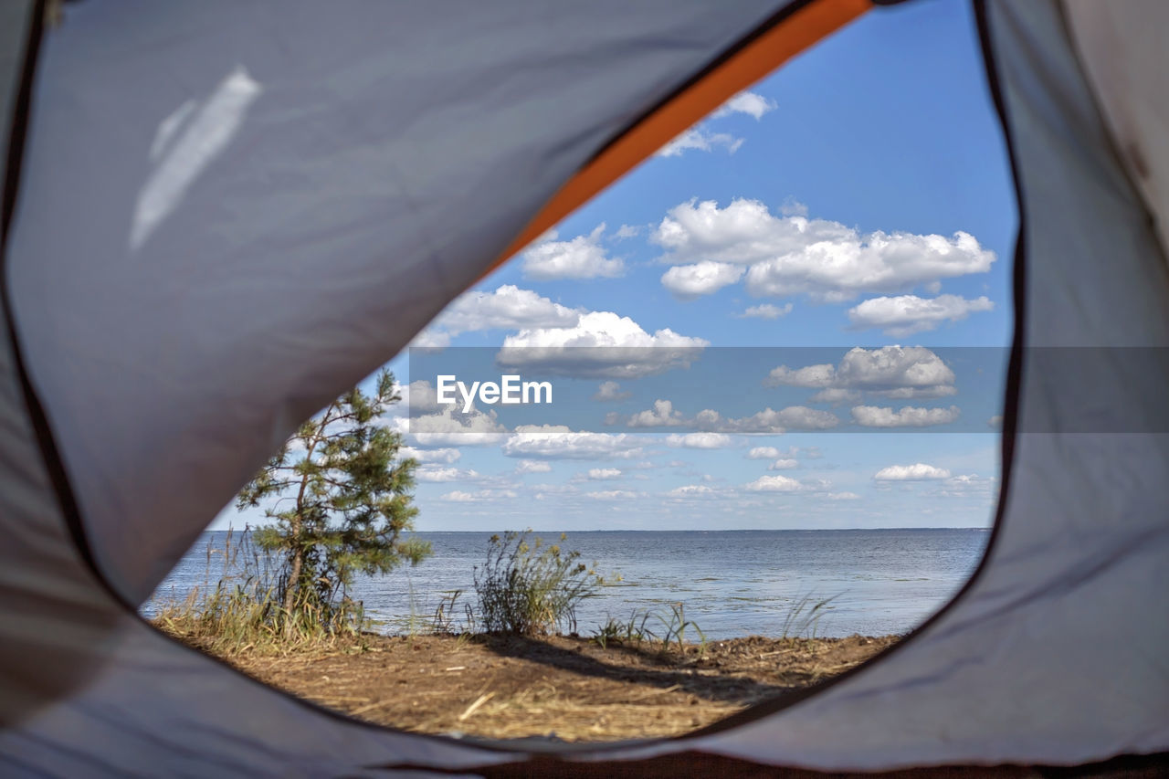 Scenic view of sea seen through tent