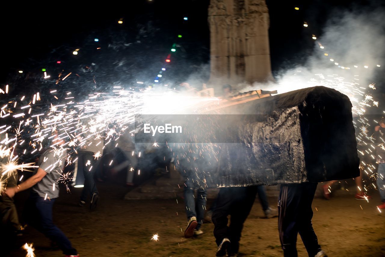 GROUP OF PEOPLE WATCHING FIREWORK DISPLAY