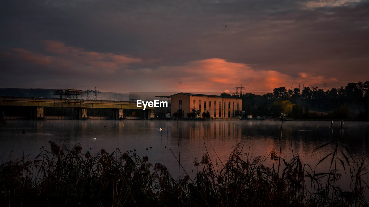 reflection, water, evening, sky, sunset, dawn, architecture, cloud, built structure, nature, building exterior, travel destinations, city, no people, beauty in nature, horizon, night, river, outdoors, plant, darkness, environment, building, tranquility, landscape, scenics - nature, travel, tourism