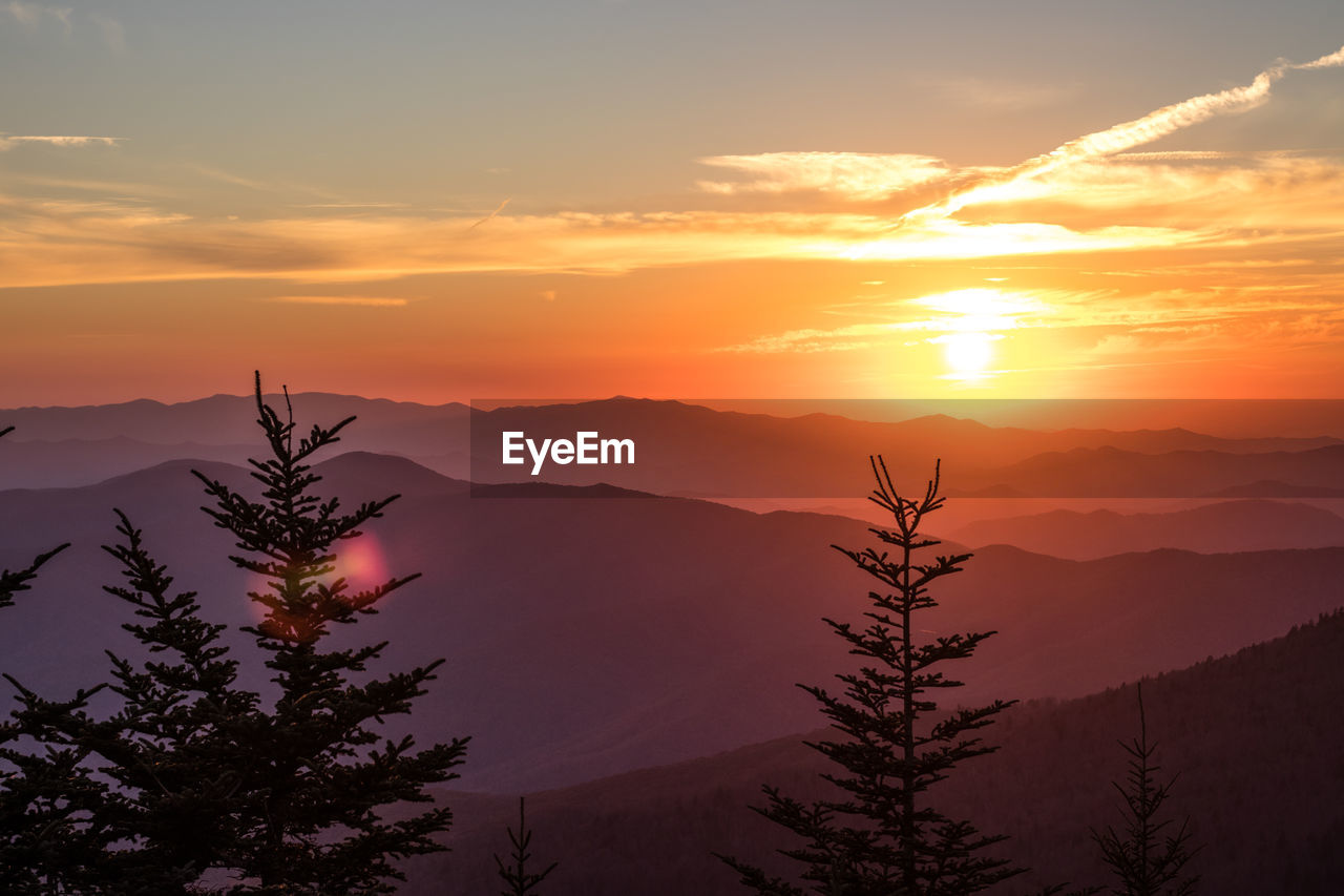 Scenic view of silhouette mountains against sky at sunset