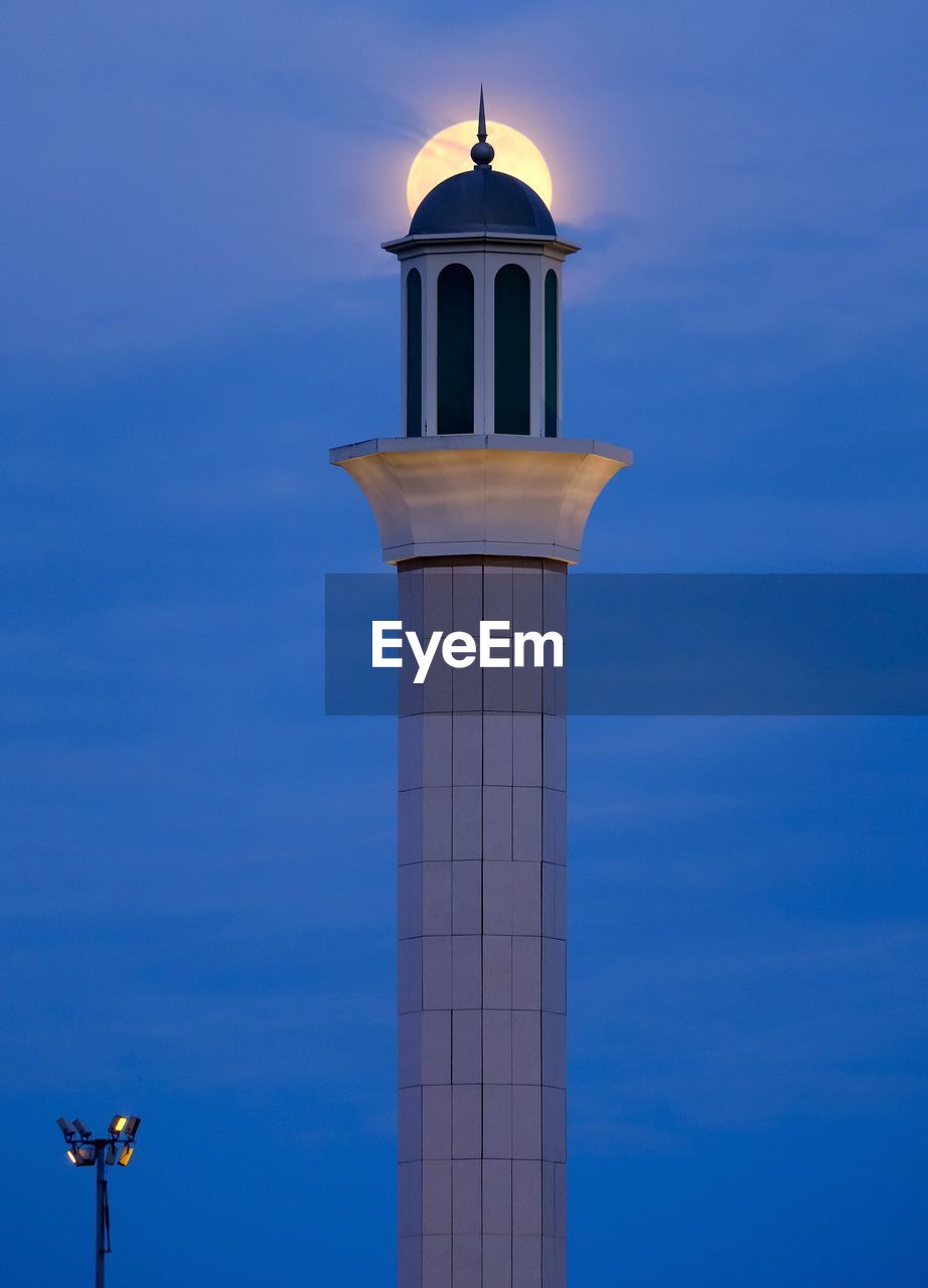 Low angle view of tower against blue sky