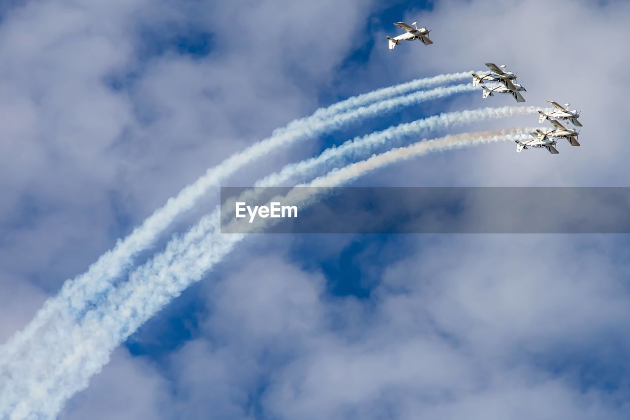 Low angle view of airshow against sky