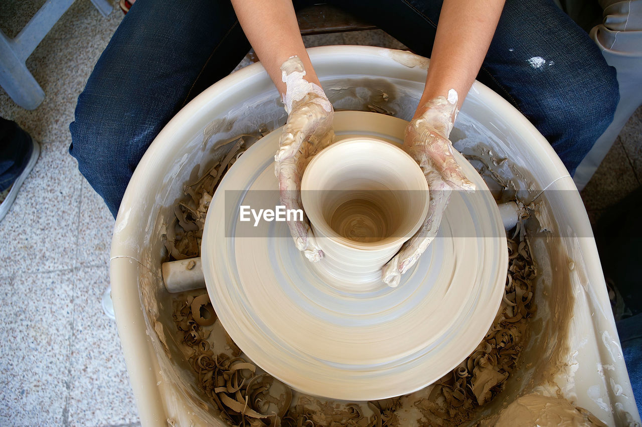 High angle view of person making pottery