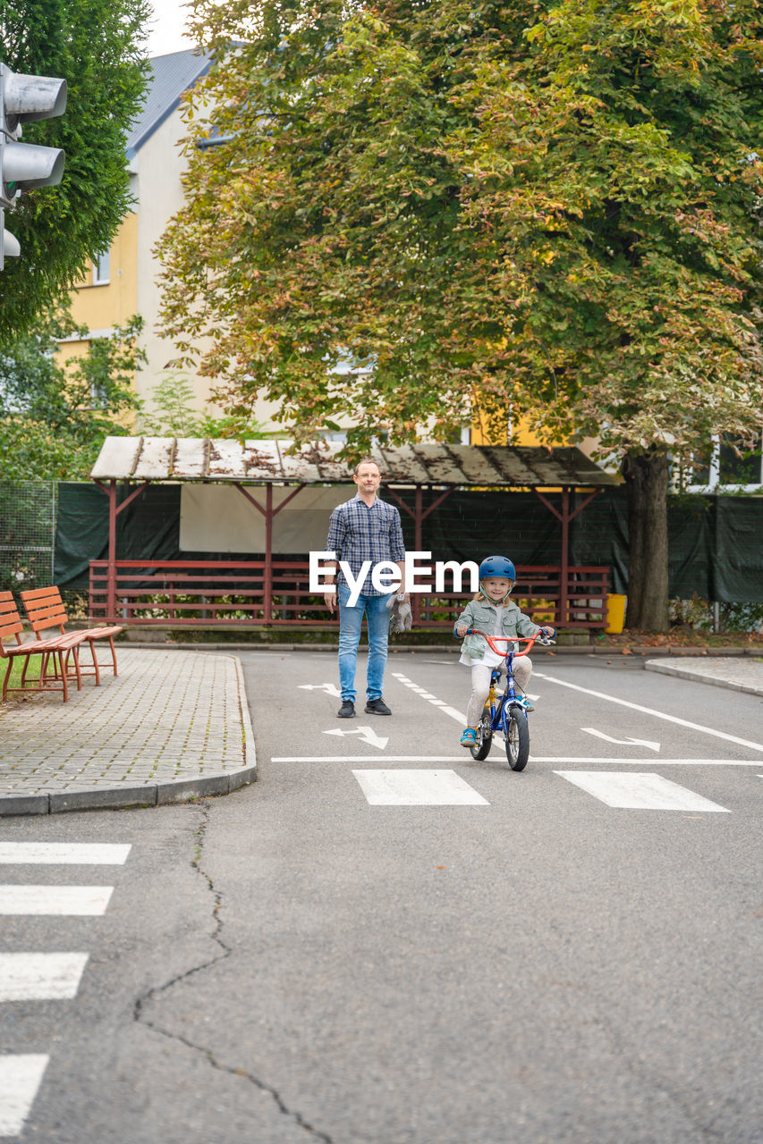 rear view of man walking on street