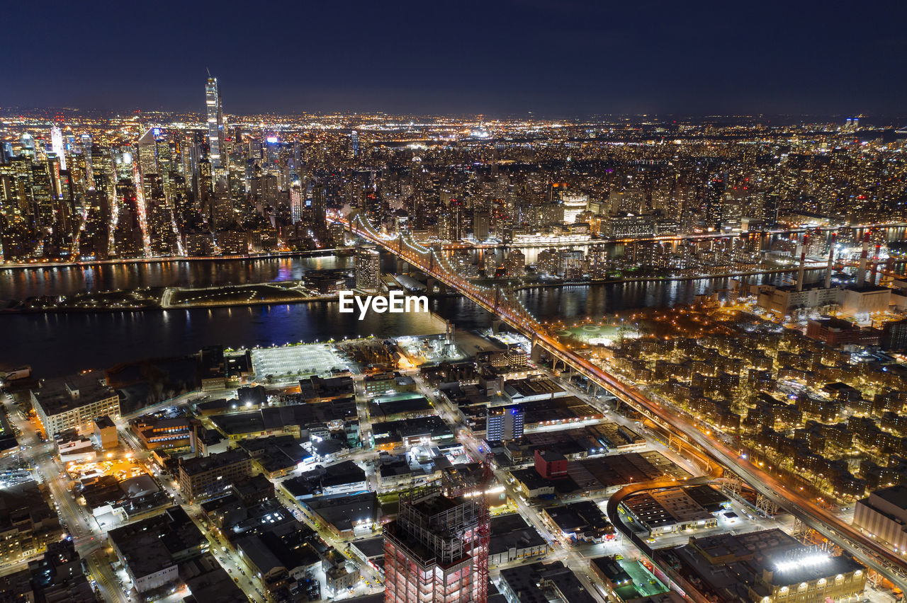 HIGH ANGLE VIEW OF ILLUMINATED CITY BUILDINGS