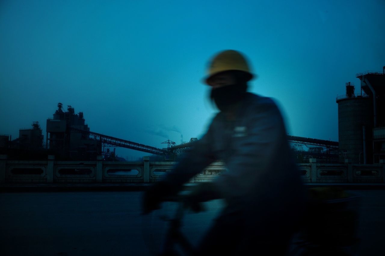 Construction worker riding bicycle