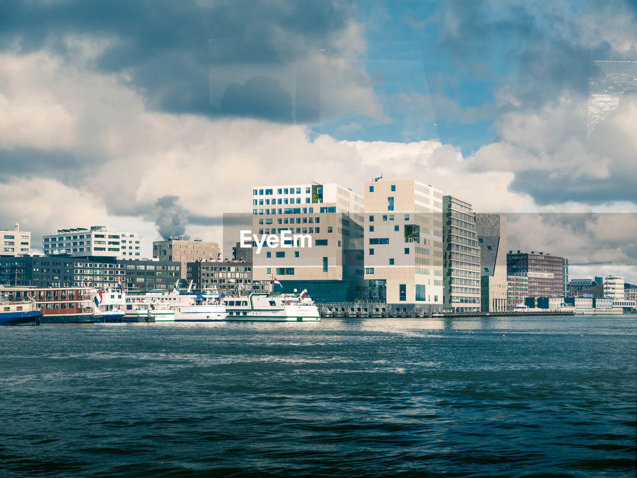 SEA AND BUILDINGS AGAINST SKY