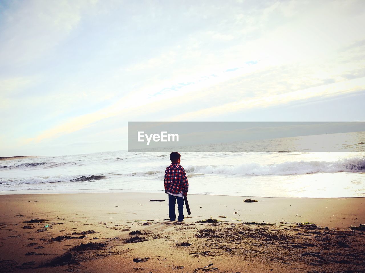 REAR VIEW OF BOY ON BEACH