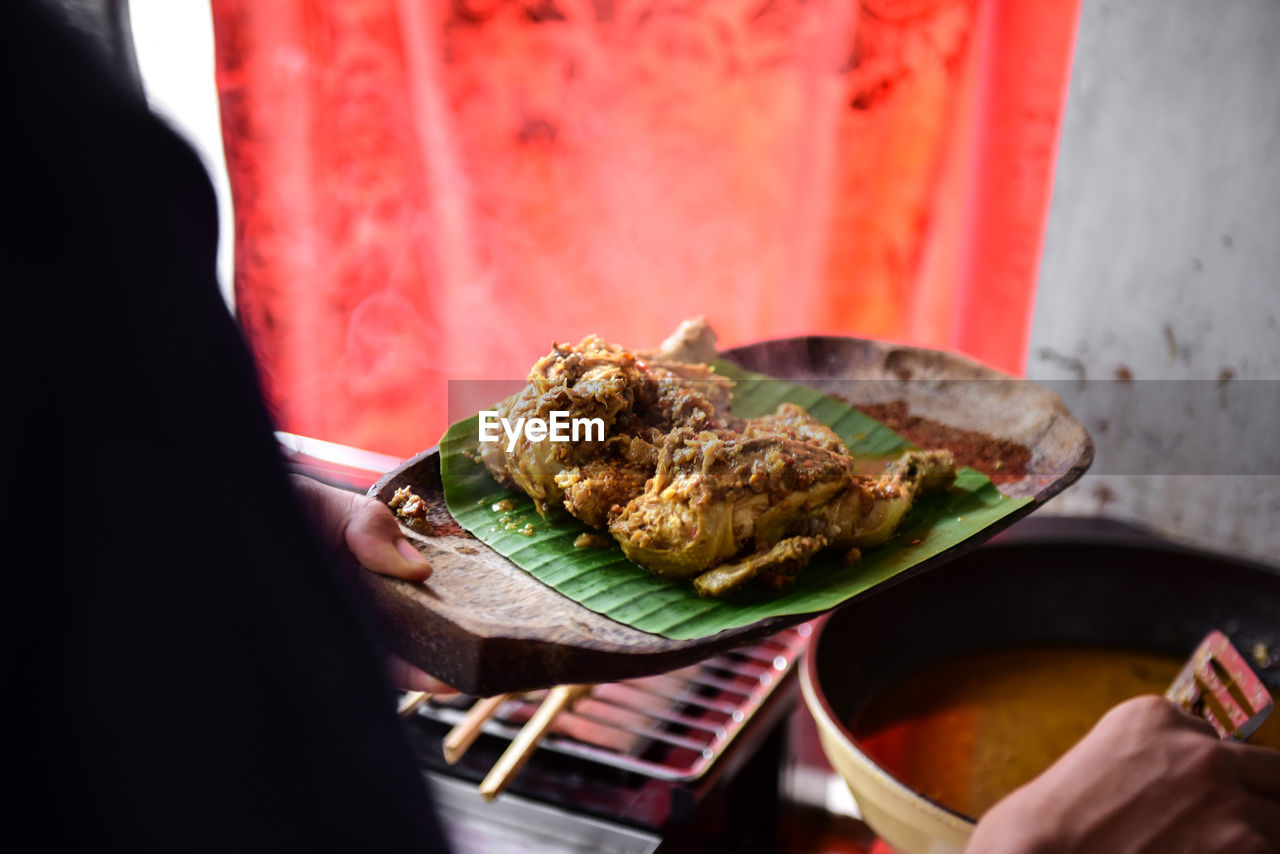 Close-up of man holding in plate