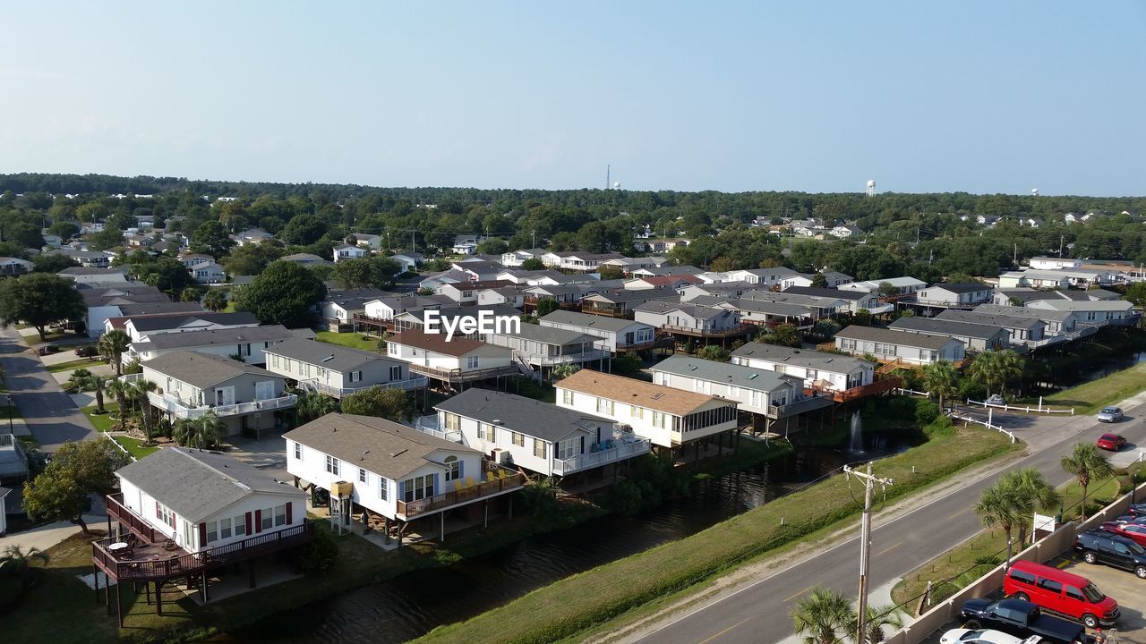 HIGH ANGLE VIEW OF RESIDENTIAL DISTRICT AGAINST SKY