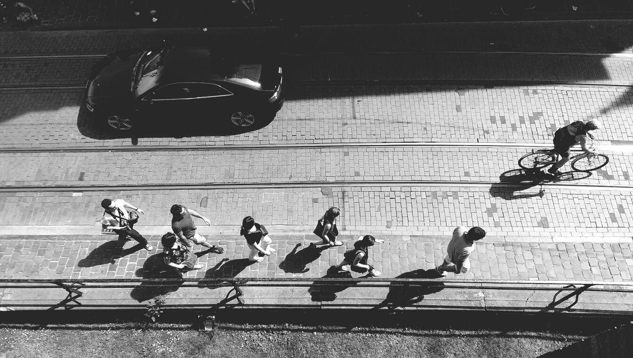 High angle view of people walking on road